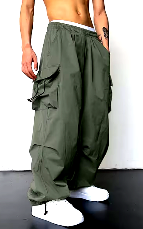 Front view of olive green cargo pants with oversized pockets and elastic waistband, styled with white sneakers.