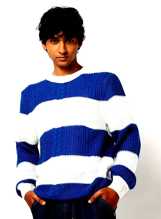 YOUSTA 3 Man wearing a blue and white striped knitted sweater with a relaxed fit.