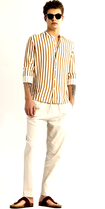 Full-body shot of a male model wearing a Snitch striped shirt with white linen trousers and brown sandals.