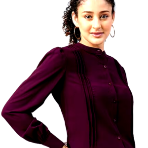 Woman wearing a plum-colored formal blouse with delicate pleats and gold hoop earrings.