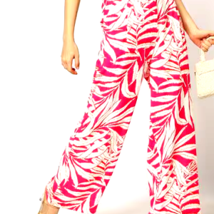 Front view of pink tropical print wide-leg pants paired with a cropped white top.