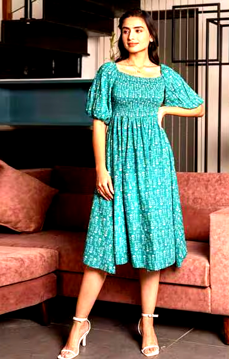 STAR WORD 5 Side view of a woman wearing a teal smocked midi dress with puffed sleeves.