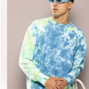 A man wearing a blue and green tie-dye sweatshirt with trendy blue sunglasses, posing confidently in front of a neutral background.