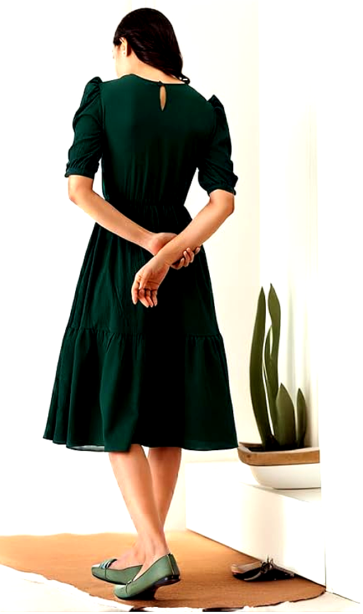 Istyle 4 Back view of a woman wearing an Istyle dark green midi dress, showcasing puff sleeves and a keyhole button design.