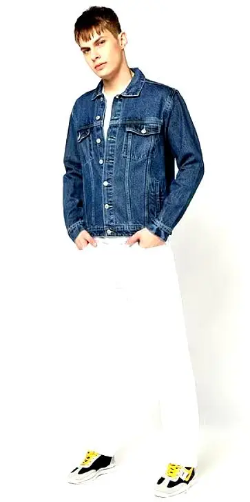  Full-body shot of a male model styled in a YOUSTA blue denim jacket paired with white pants and sneakers.