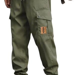 Close-up of a person wearing olive green cargo pants with elastic cuffs, tan work boots, and a black shirt, standing with a brown backpack.