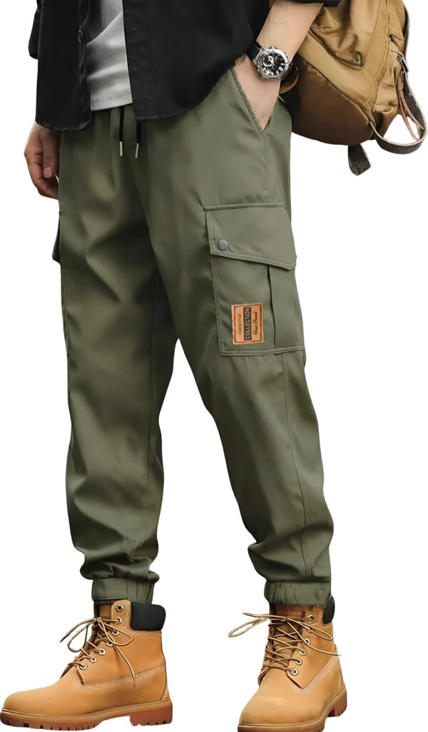 Close-up of a person wearing olive green cargo pants with elastic cuffs, tan work boots, and a black shirt, standing with a brown backpack.