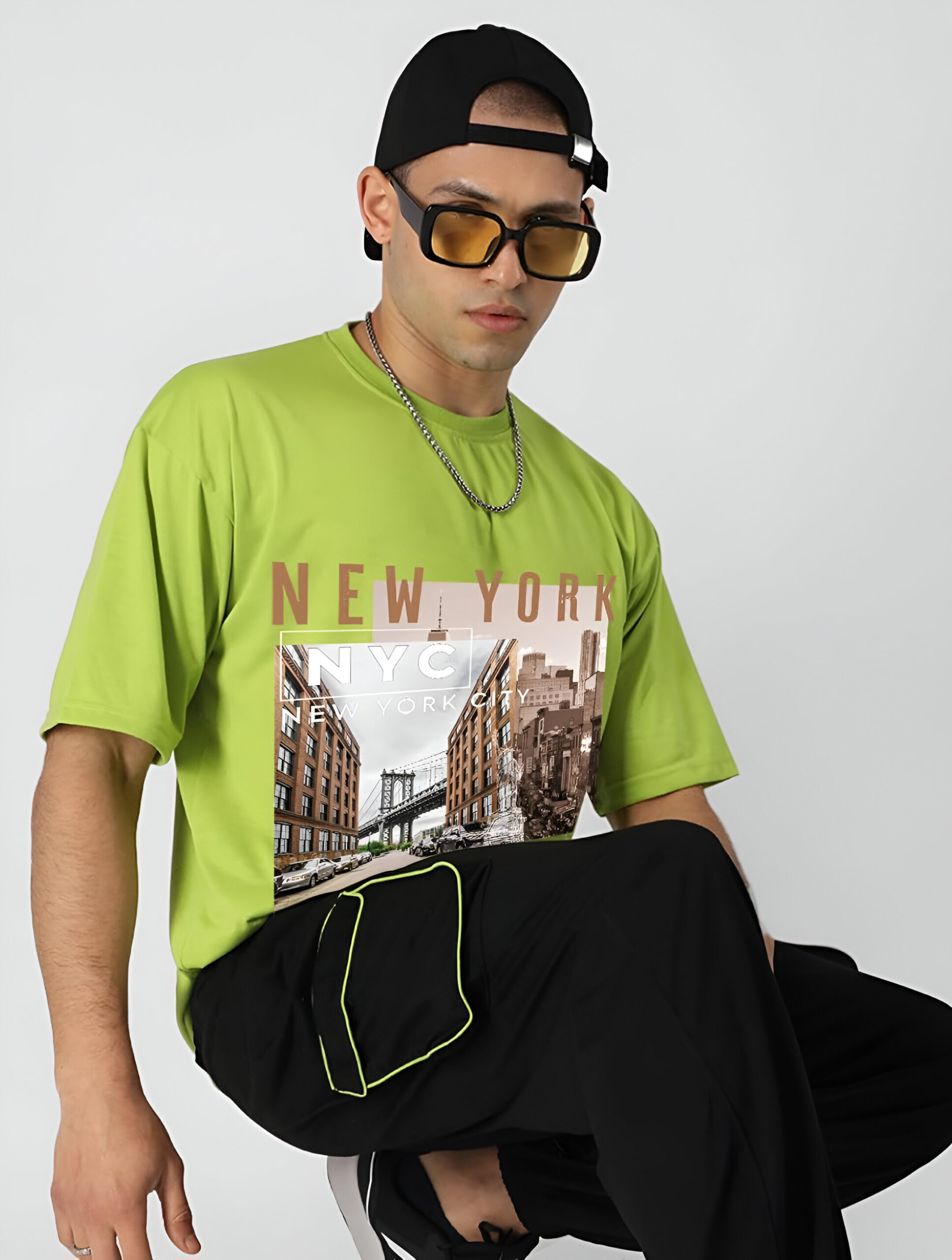  Man wearing a neon green NYC-themed T-shirt.