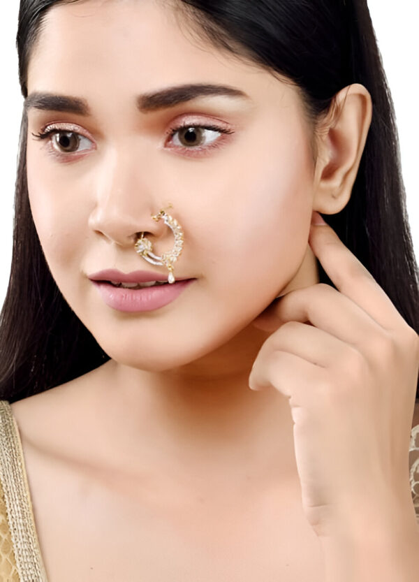 Woman wearing an elegant crescent-shaped bridal nose ring with intricate stone detailing, showcasing traditional ethnic jewelry.